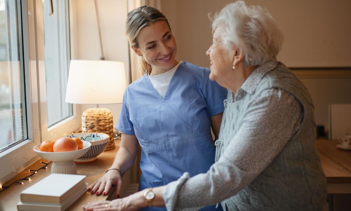 Caregiver and an older woman together in the kitchen